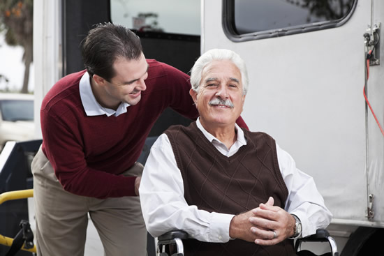 man pushing dad in wheelchair